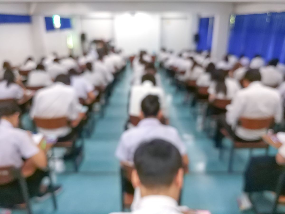 Students sit in the exam room blur image.